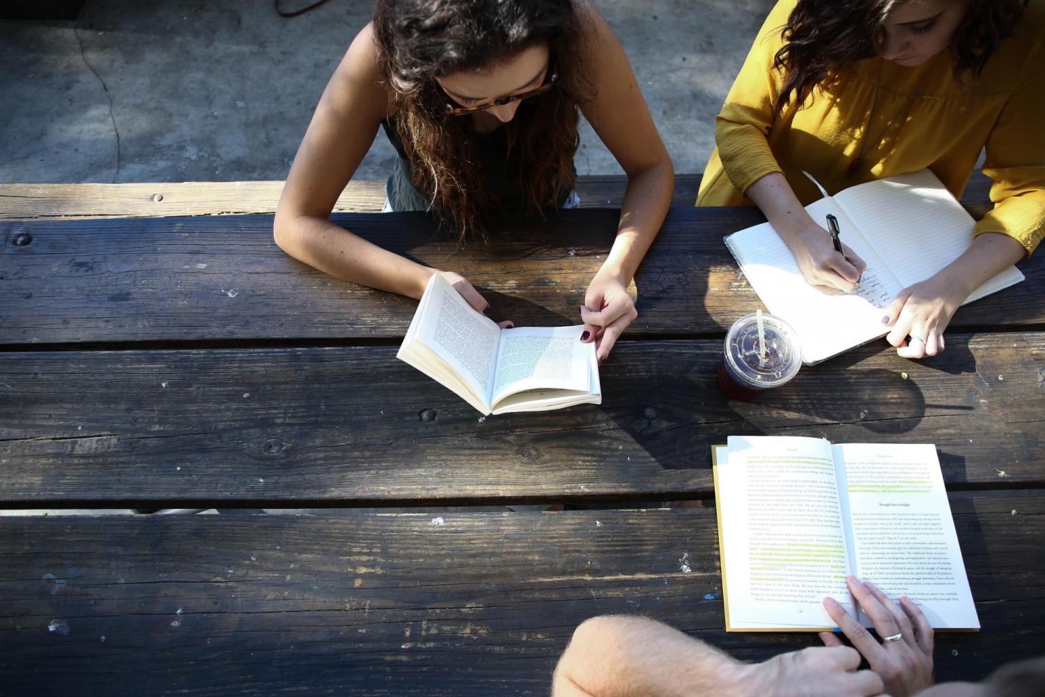 Three women working at a picnic table