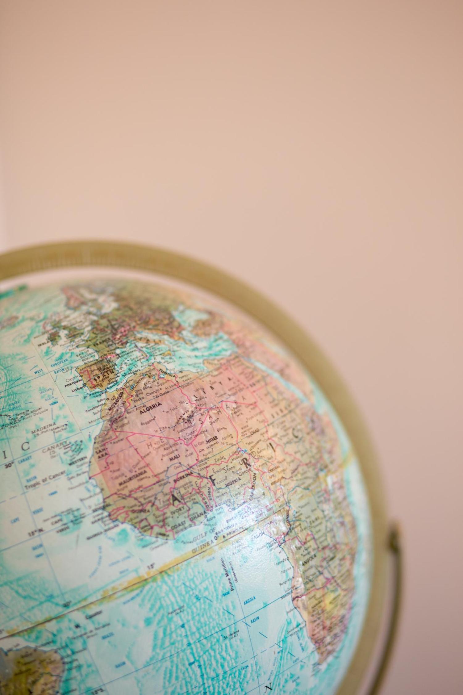 globe against a pink background