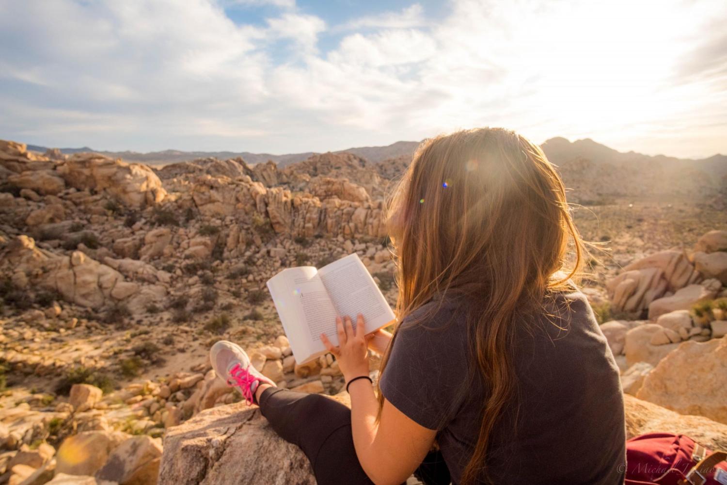woman reading book outdoors