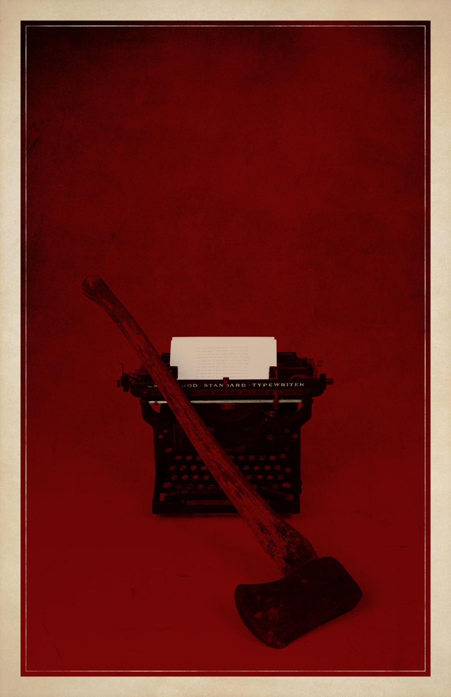 Image of an old typewriter with and ax in front of it.