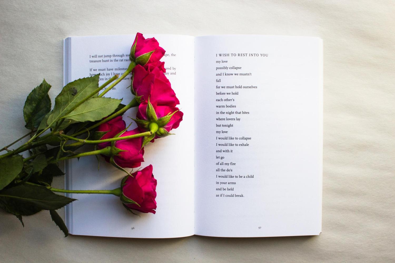 six roses on a book of poetry
