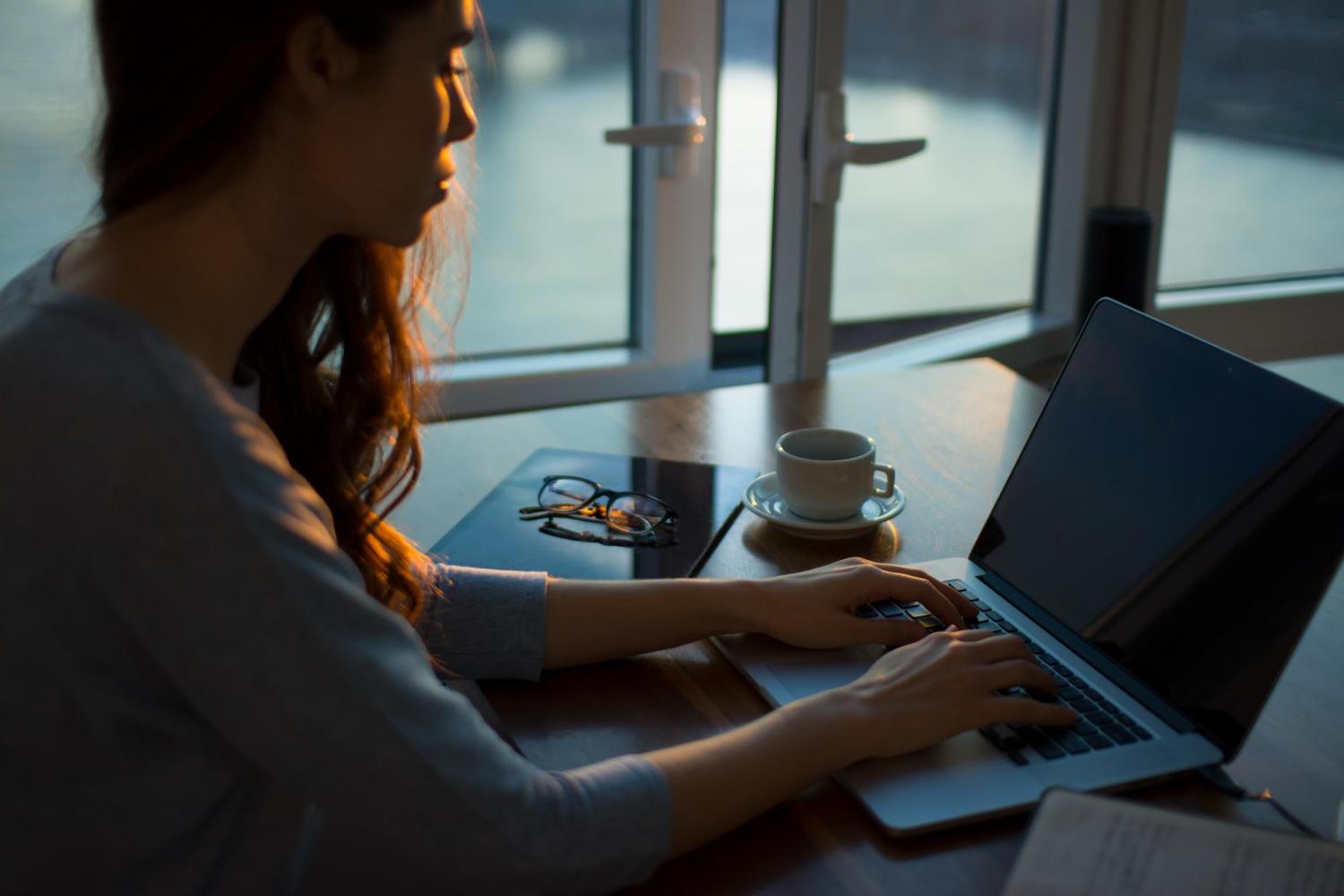 A woman at a table writing