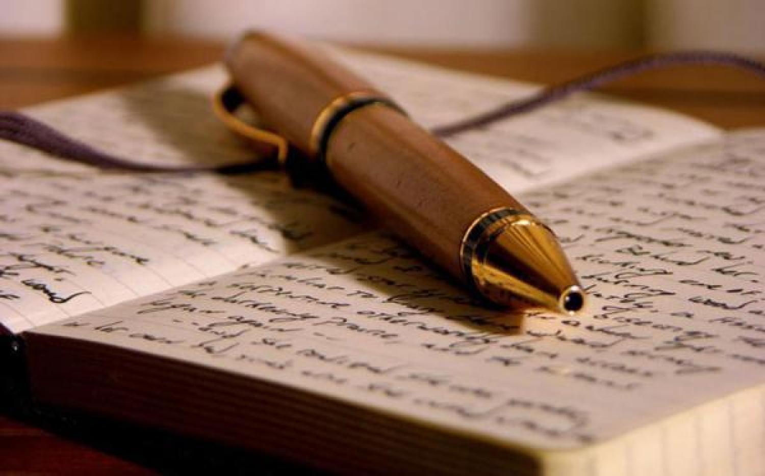 A fountain pen resting on an open book