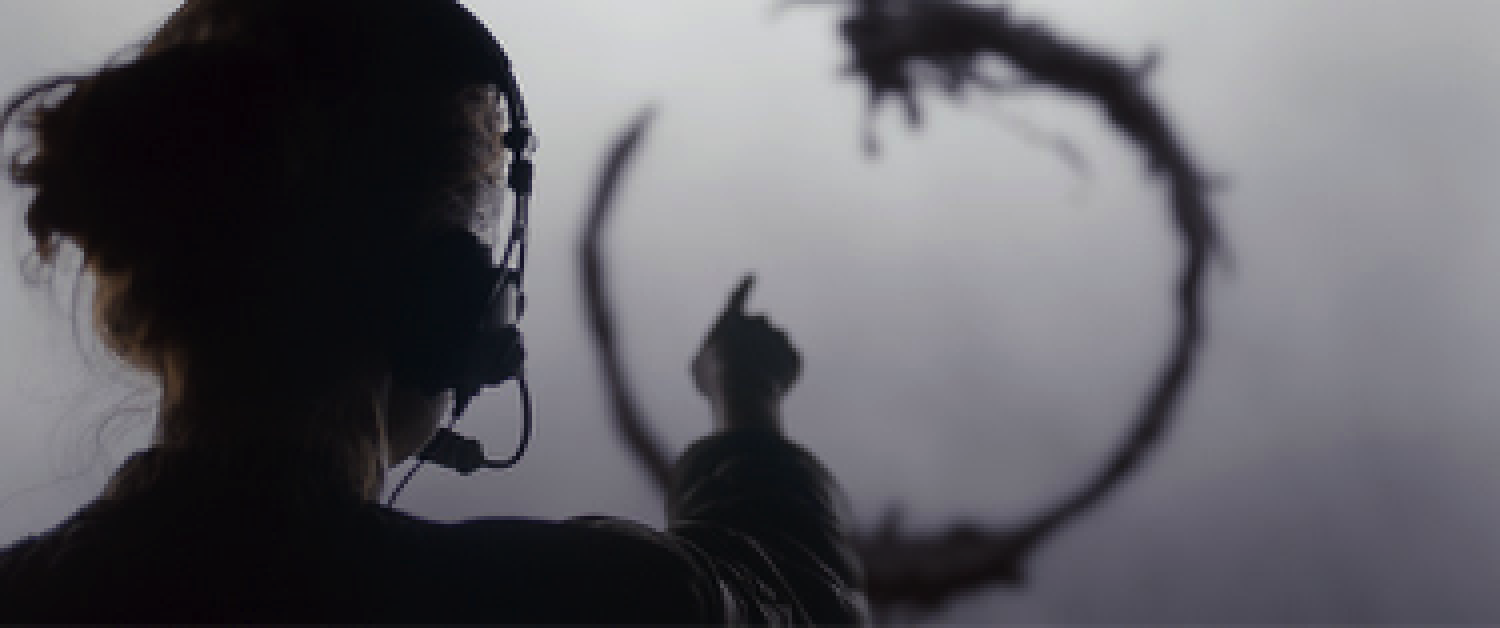 Amy Adams pointing at graphic from the film Arrival