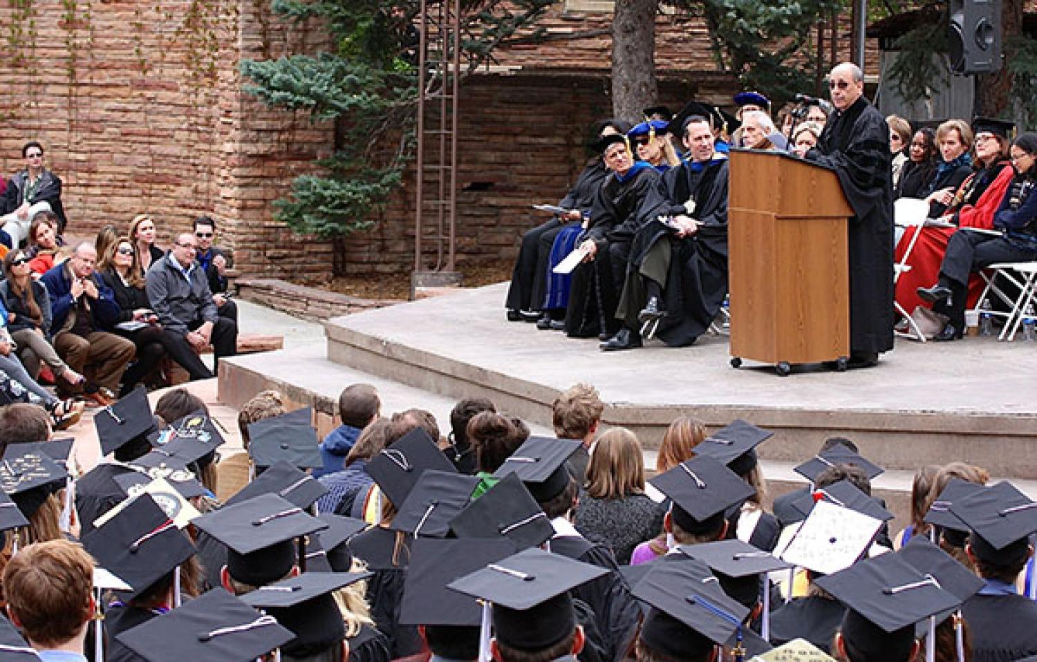 Art Kaufman speaking in front of student sat spring 2015 commencement