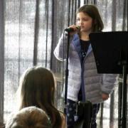 girl reciting poetry into microphone