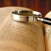 A magnifying glass on an open book