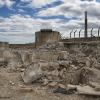 Depicts what alumna means about dire future showing a run down building and landscape. 