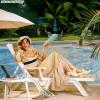 Drawing of a Victorian woman laying by a pool with modern things like a cell phone, sunglasses, Variety magazine, etc. 