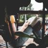 Woman on park bench with a notebook