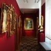 gold framed art on a red wall