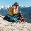 Woman writing on a mountaintop