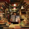 WOMAN SURROUNDED BY BOOKS