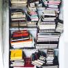 a bunch of books stacked in a stairwell