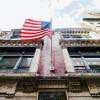american flag flying over a building