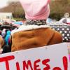 Woman with a pink hat and a sign that reads Times Up