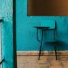 A blue chair against a blue wall