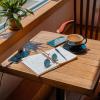 An open notebook on a table in the sunshine