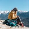 woman writing on top of a mountain
