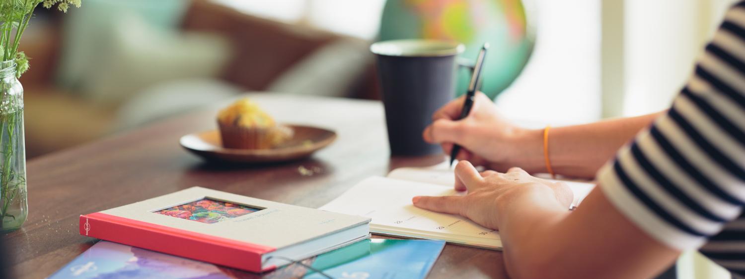 woman writing at desk