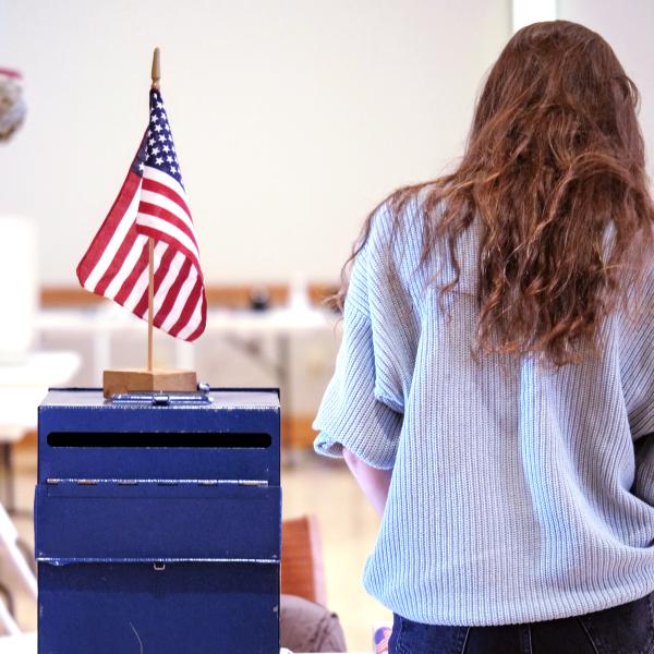 Woman votes at a ballot box