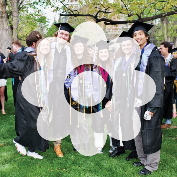 Flower graphic in front of a crowd of grads