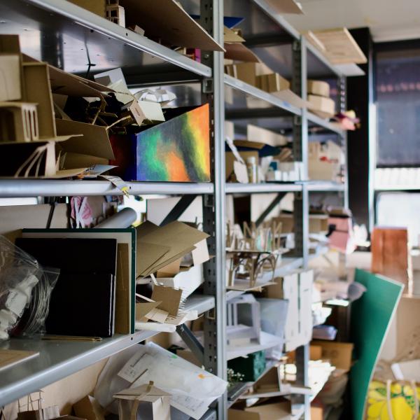 Photo of studio shelf covered in student work and projects