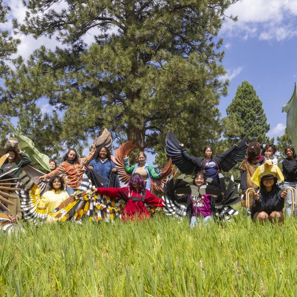 side by side cohort of undergrads and high school youth dressed in bird costumes
