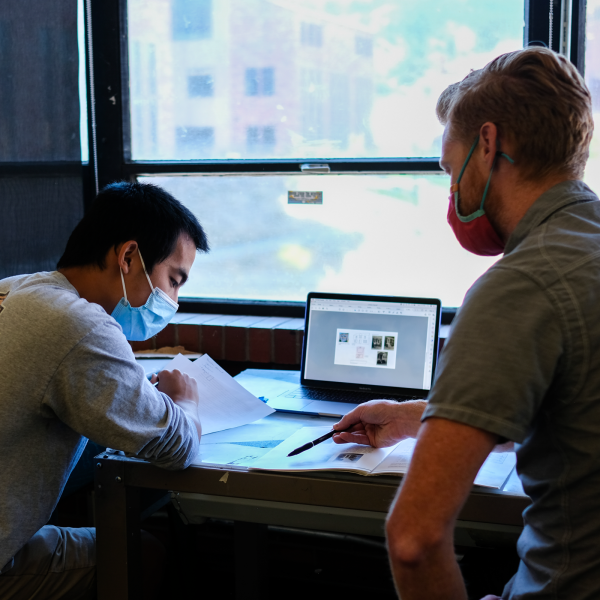 Associate Director of Undergraduate Education Neal Evers speaks with a student during a Latin Honors course
