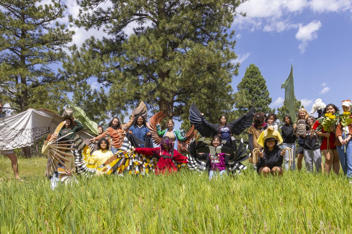 side by side cohort of undergrads and high school youth dressed in bird costumes