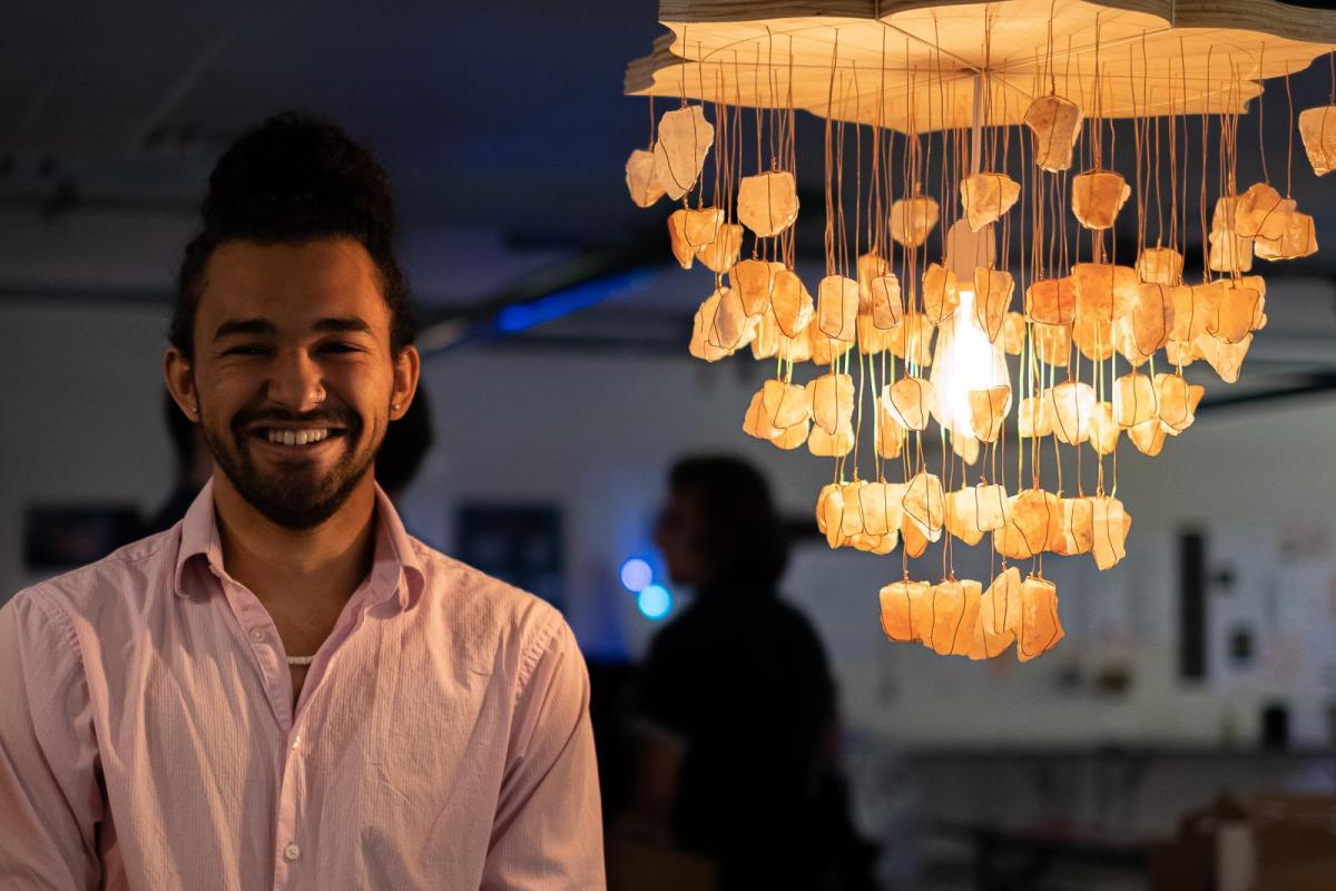 Zane Mitchell-Almoustapha with his digi-fab lamp, Sacral Chakra Chandelier