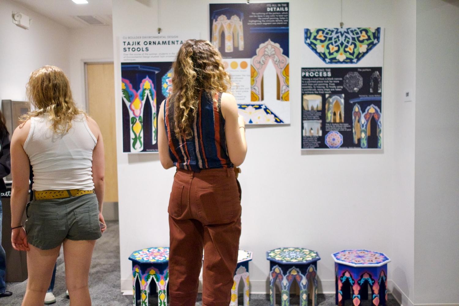 Dushanbe Teahouse symposium participant views student work on walls