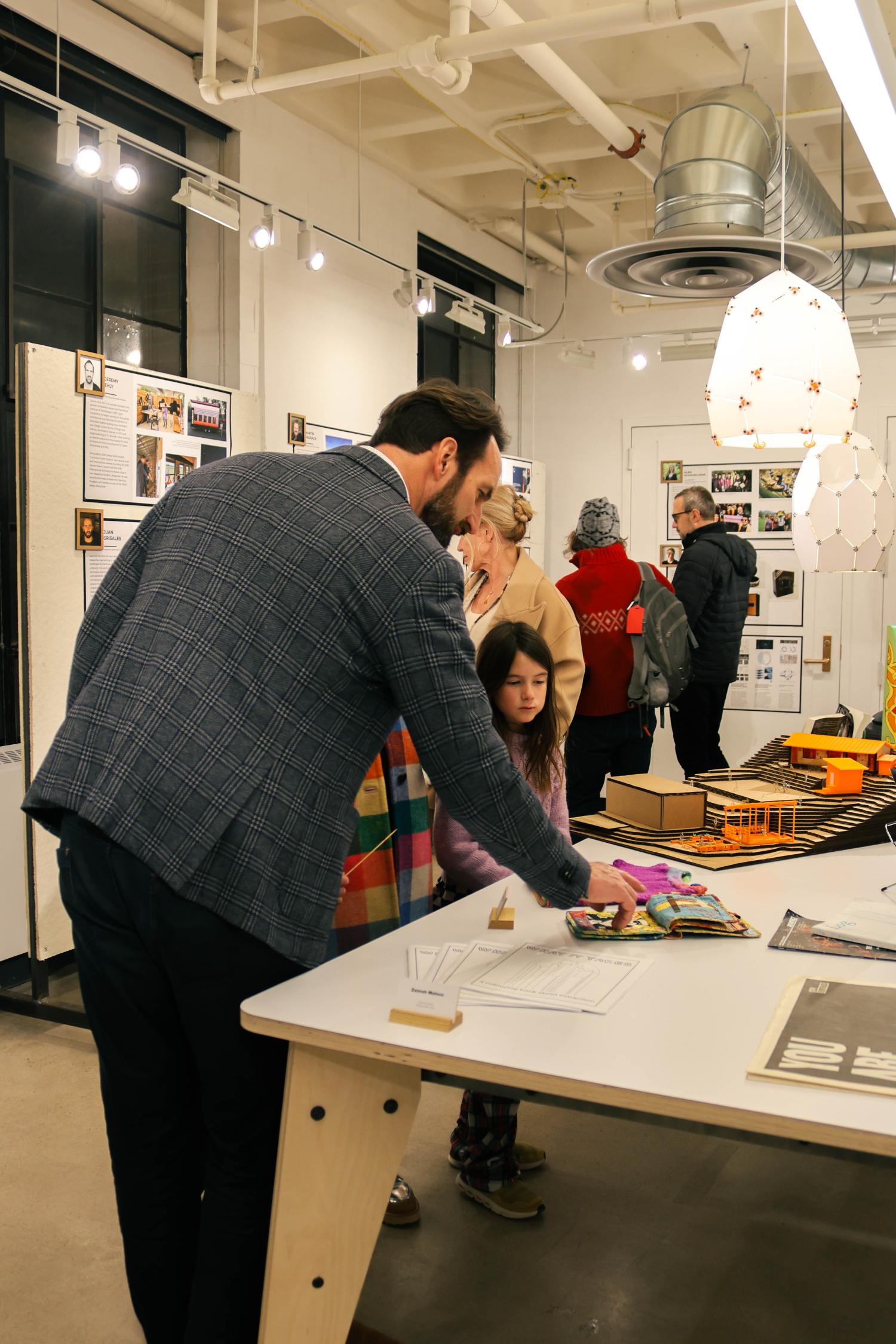 Open House visitors look at student work