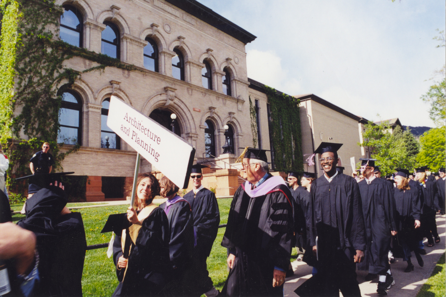 Peg holding sign at graduation