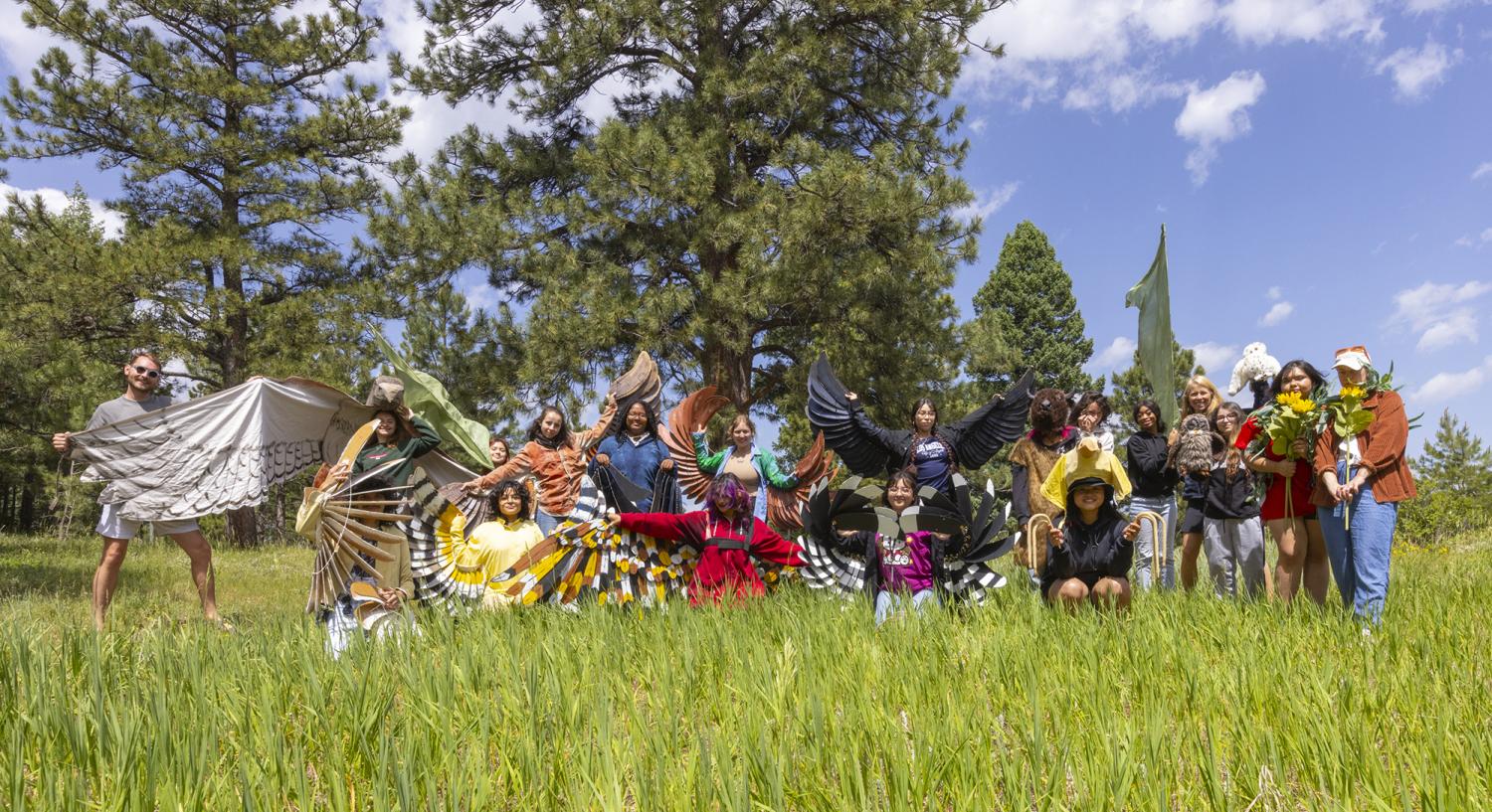 side by side cohort of undergrads and high school youth dressed in bird costumes