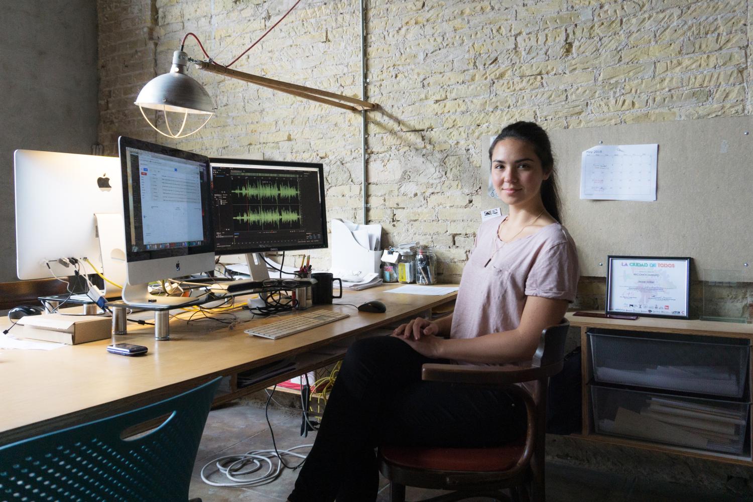 Sara Taketatsu sits at her desk while interning with bcWORKSHOP in Brownsville, Texas.