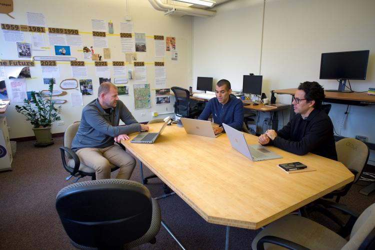 Nate, Jota, and Shawhin sit around a table in CEDaR