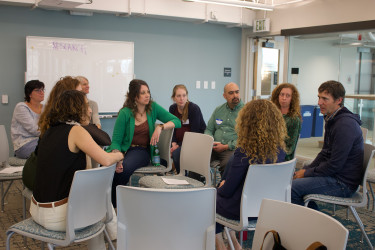 Attendees gather in small groups and chat