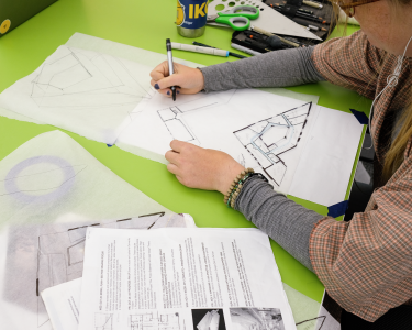 student working on design at desk