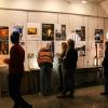 Students look at student work pinned to the walls at Open House
