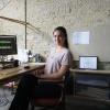 Sara Taketatsu sitting at her desk while interning with bcWORKSHOP.