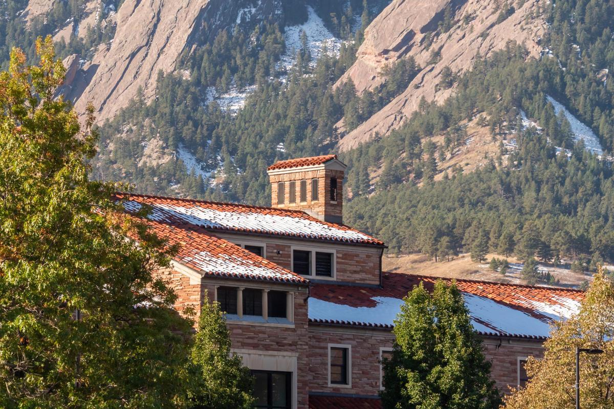 Image of a CU Boulder Building with the Flatirons in the background