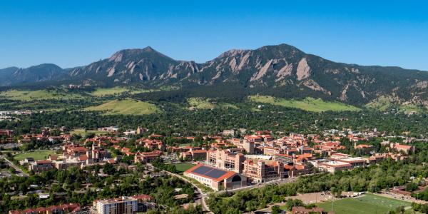Aerial image of CU Boulder campus with the Flatirons in the background 