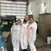 three students stand together auditing waste at vail