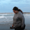 Emily Nocito walking along beach