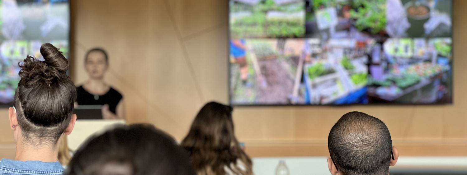 Two students watching a presentation in the Colloquium Series