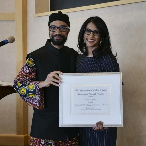 Dr. Seema Sohi recieving the Chair's Distinguished Service Award from Dr. Reiland Rabaka