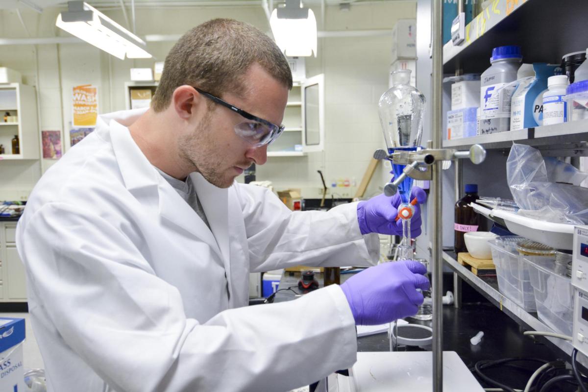 A student working with a pipette.