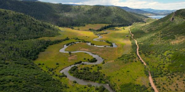 Aerial photo of a winding river in the mountains.