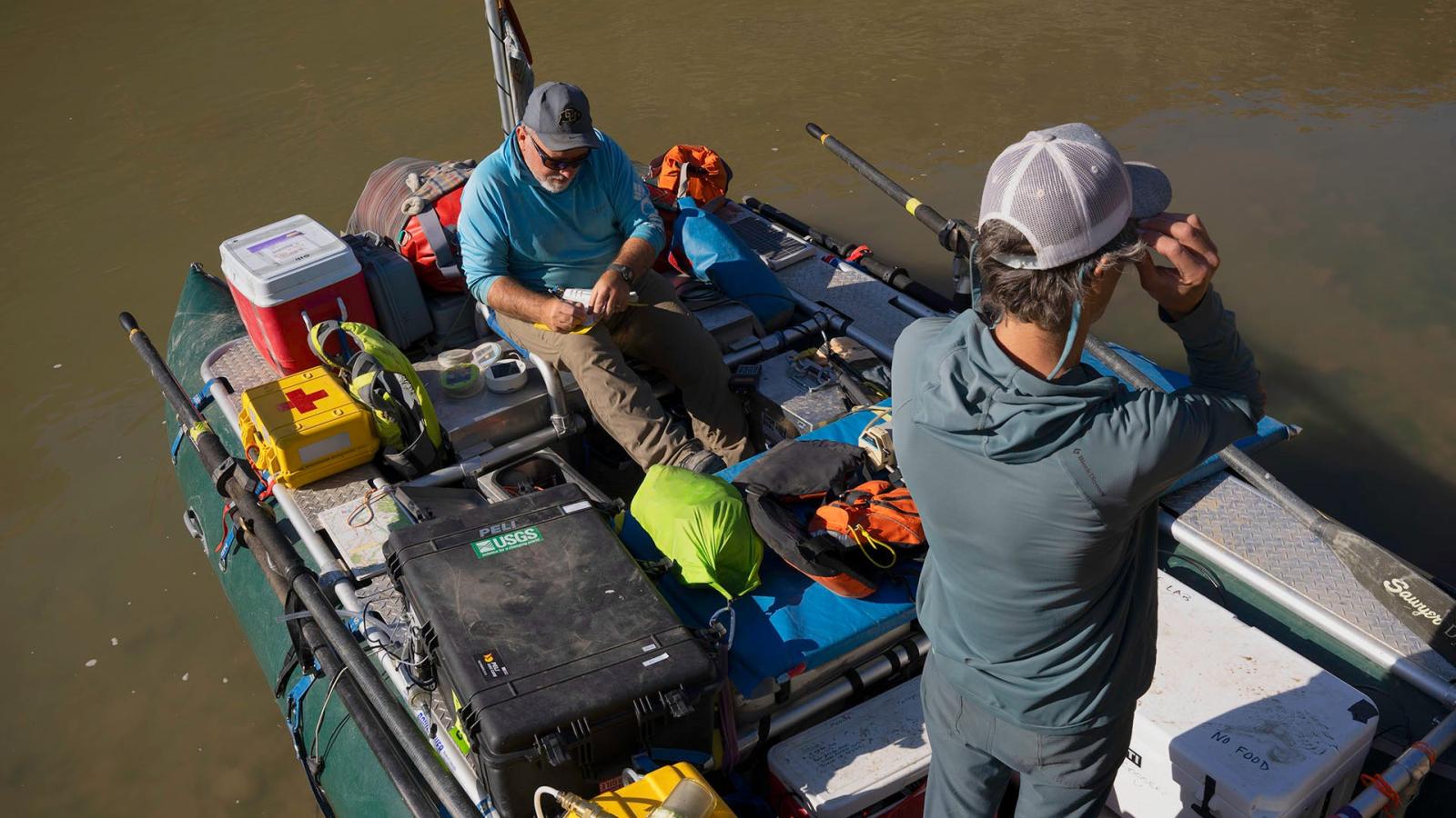 Newman and Gooseff prepare for a day of sampling on a raft.
